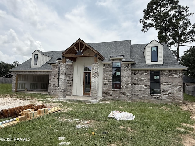 122 Preservation Dr, Youngsville, LA 70592 - view of front facade with brick siding, a shingled roof, and an attached garage