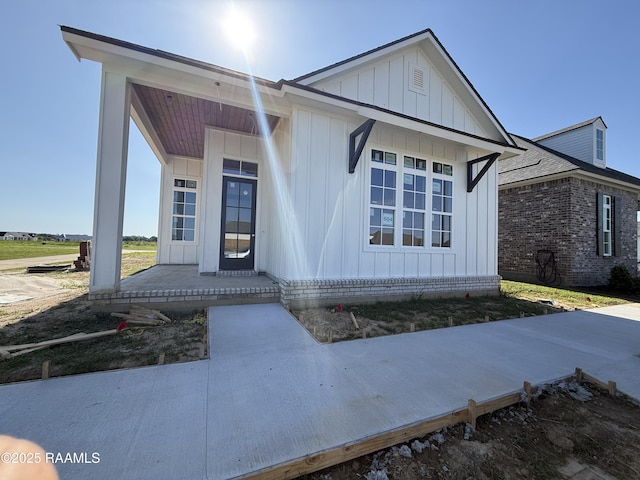 view of front facade featuring board and batten siding and covered porch