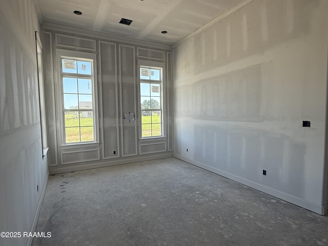 spare room with baseboards and visible vents