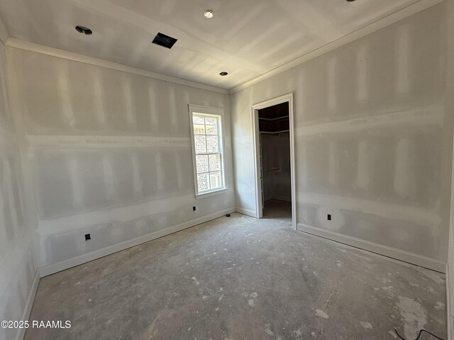 unfurnished bedroom featuring crown molding, a closet, and baseboards