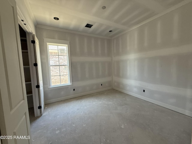 spare room featuring concrete floors and baseboards