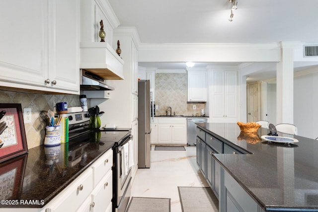 112 Hillside Dr Unit 3, Lafayette, LA 70503 - kitchen with white cabinets, under cabinet range hood, a sink, stainless steel appliances, and a spacious island