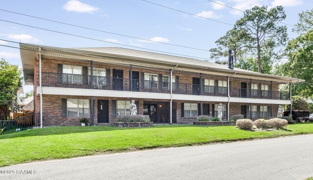 112 Hillside Dr Unit 3, Lafayette, LA 70503 - view of front of home featuring a front yard, fence, and brick siding