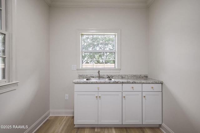 1013 Young St, Broussard, LA 70518 - interior space with light wood-type flooring, baseboards, a sink, and ornamental molding