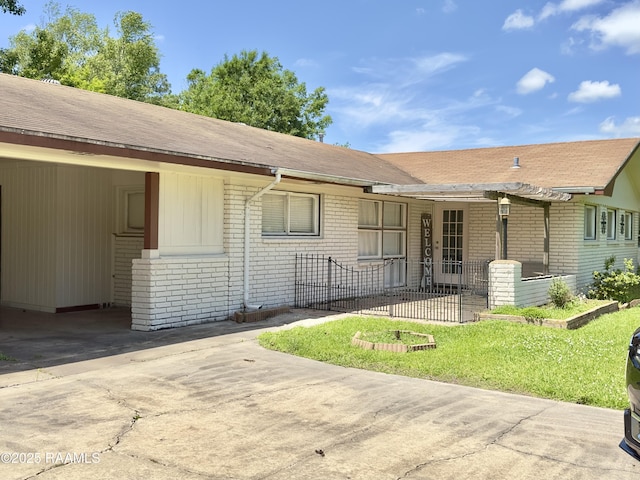 820 Genevieve Dr, Lafayette, LA 70503 - view of front facade featuring brick siding, driveway, and roof with shingles