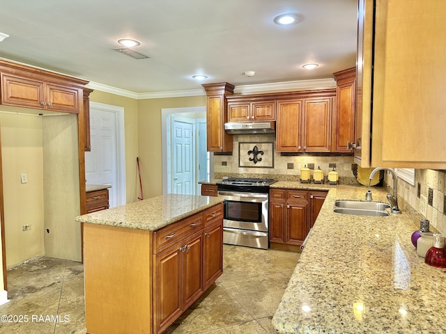 820 Genevieve Dr, Lafayette, LA 70503 - kitchen featuring a sink, under cabinet range hood, tasteful backsplash, crown molding, and gas range