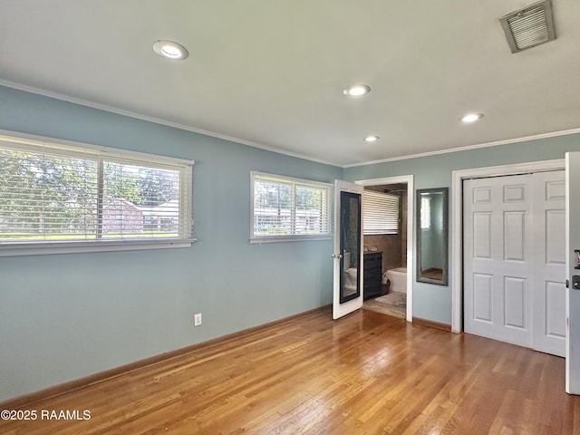 820 Genevieve Dr, Lafayette, LA 70503 - unfurnished bedroom featuring recessed lighting, light wood-style flooring, baseboards, visible vents, and crown molding