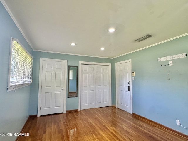 820 Genevieve Dr, Lafayette, LA 70503 - unfurnished bedroom with a closet, crown molding, visible vents, baseboards, and wood finished floors
