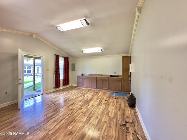 820 Genevieve Dr, Lafayette, LA 70503 - empty room featuring light wood finished floors, electric panel, vaulted ceiling, baseboards, and ornamental molding