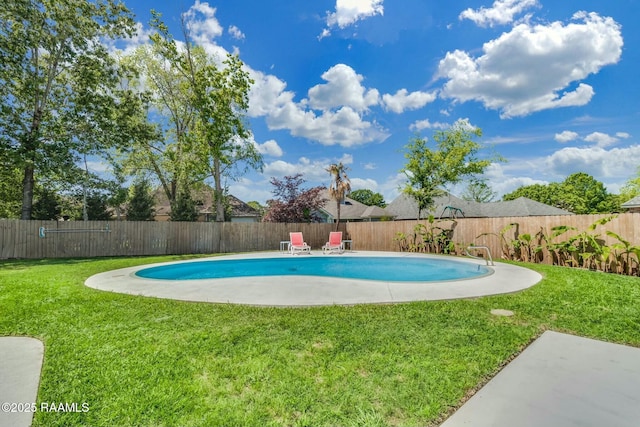 view of swimming pool featuring a fenced backyard, a fenced in pool, a yard, and a patio area