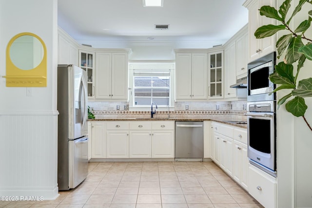 kitchen featuring a sink, appliances with stainless steel finishes, white cabinets, and visible vents