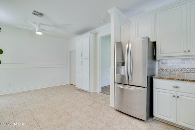 kitchen featuring decorative backsplash, a ceiling fan, stainless steel refrigerator with ice dispenser, visible vents, and white cabinets