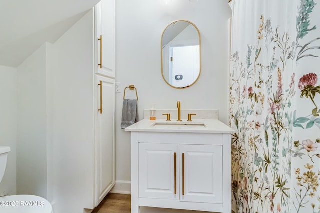 full bath with vanity, toilet, and wood finished floors
