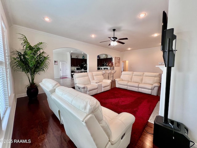 1935 Heberts Pass, Lake Charles, LA 70607 - living room with crown molding, ceiling fan, arched walkways, and wood finished floors