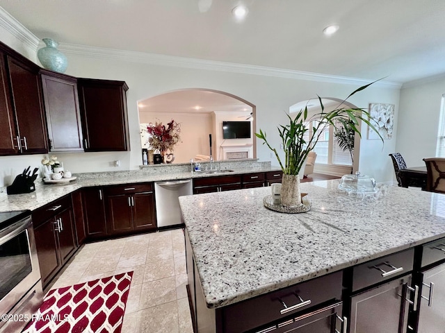 1935 Heberts Pass, Lake Charles, LA 70607 - kitchen featuring arched walkways, ornamental molding, appliances with stainless steel finishes, dark brown cabinets, and light stone countertops