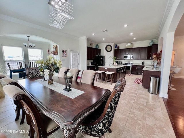 1935 Heberts Pass, Lake Charles, LA 70607 - dining room featuring visible vents, arched walkways, a chandelier, crown molding, and recessed lighting