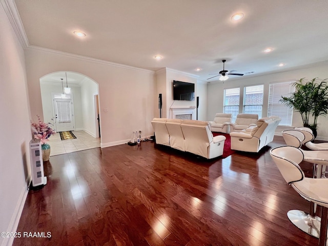 1935 Heberts Pass, Lake Charles, LA 70607 - living room featuring arched walkways, ceiling fan, baseboards, and dark wood-style floors
