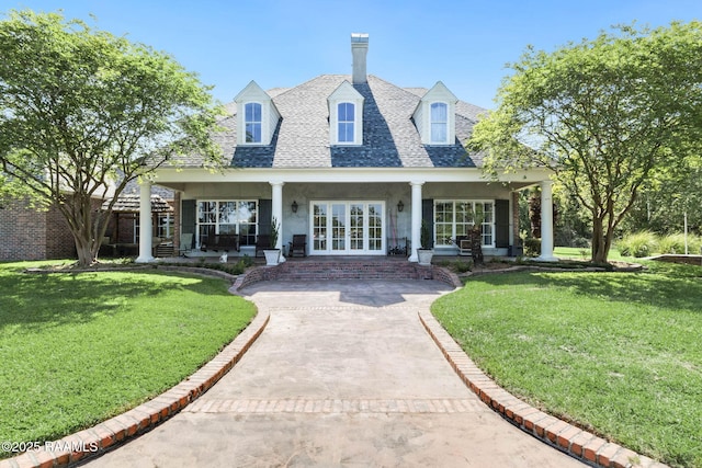 exterior space with a yard, french doors, a porch, and a shingled roof