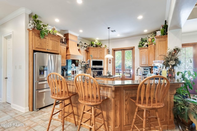 kitchen with a kitchen breakfast bar, a healthy amount of sunlight, stainless steel appliances, a peninsula, and recessed lighting