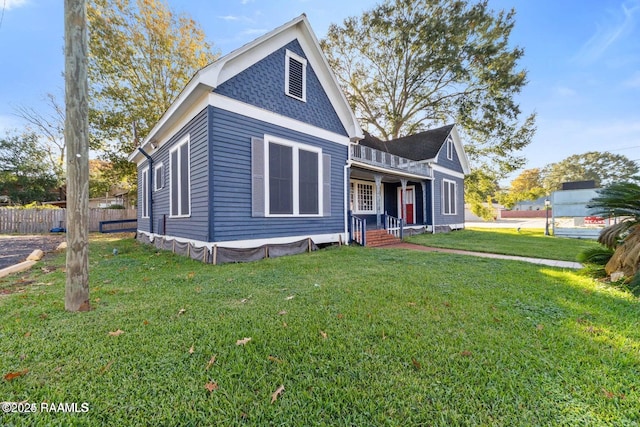 view of front of house with fence and a front yard