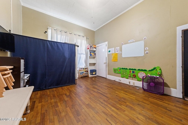 interior space with hardwood / wood-style floors, crown molding, and baseboards