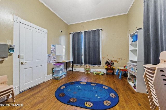 playroom with hardwood / wood-style floors, attic access, baseboards, and ornamental molding