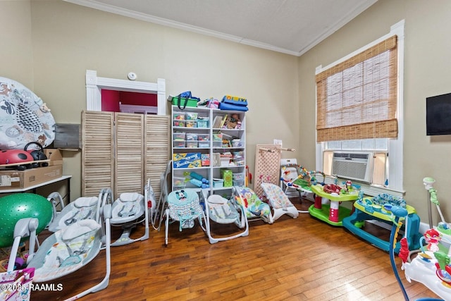 game room with hardwood / wood-style floors, cooling unit, and crown molding