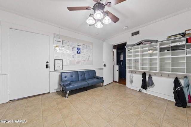unfurnished room with ceiling fan, ornamental molding, tile patterned floors, and visible vents