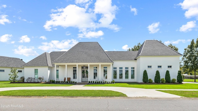301 Greyford Dr, Lafayette, LA 70503 - french country home with a front lawn, covered porch, curved driveway, and stucco siding