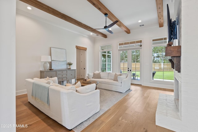 301 Greyford Dr, Lafayette, LA 70503 - living area with light wood finished floors, visible vents, beamed ceiling, a fireplace, and ceiling fan