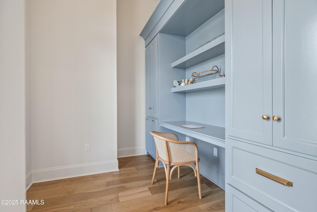 301 Greyford Dr, Lafayette, LA 70503 - home office with built in study area, baseboards, and light wood-style floors