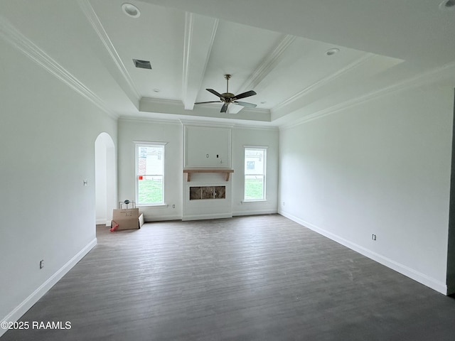 214 Berchman Oaks Dr, Lafayette, LA 70506 - unfurnished living room featuring arched walkways, a tray ceiling, crown molding, ceiling fan, and dark wood-style flooring