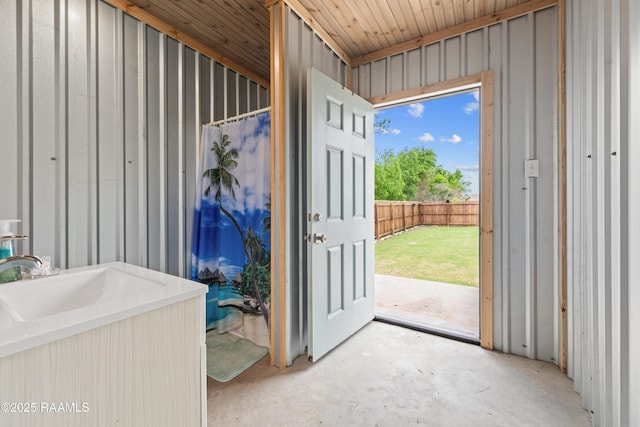 doorway to outside with concrete flooring and a sink