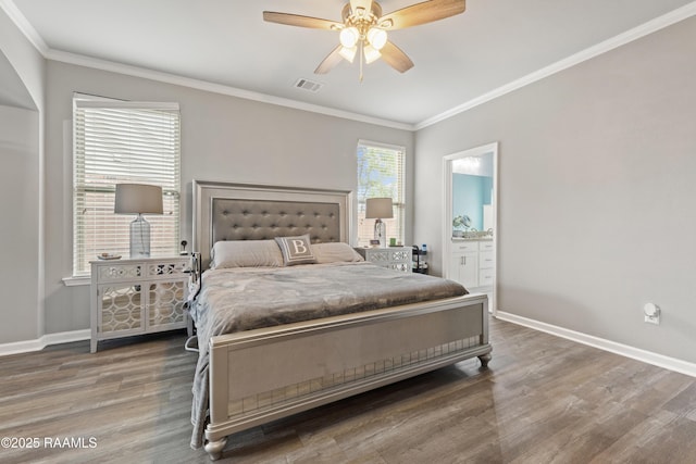 bedroom featuring multiple windows, wood finished floors, baseboards, and ornamental molding