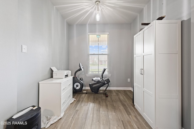 office space with baseboards and wood finished floors