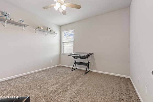 carpeted spare room featuring a ceiling fan and baseboards