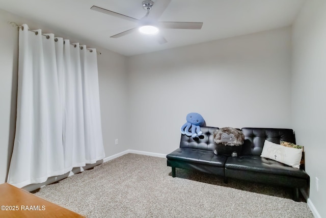 sitting room with carpet floors, baseboards, and ceiling fan