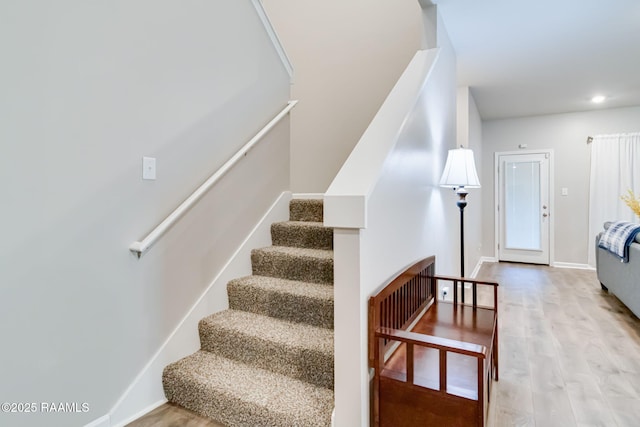 stairway with wood finished floors