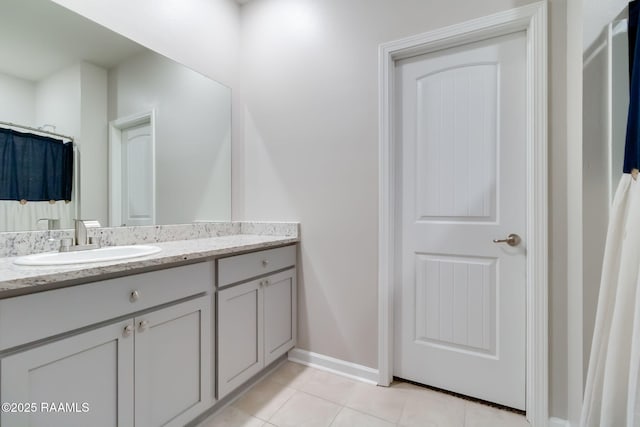 bathroom featuring tile patterned floors, baseboards, and vanity