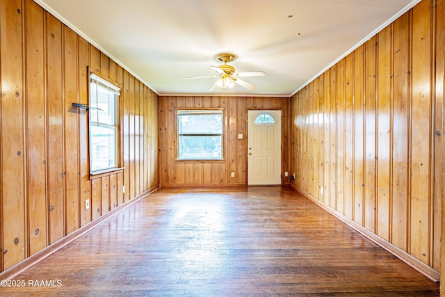 204 Eastland Dr, Lafayette, LA 70503 - unfurnished room with wooden walls, wood finished floors, ceiling fan, and crown molding