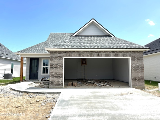 305 Bennington Ln, Youngsville, LA 70592 - view of front of house featuring a shingled roof, brick siding, a garage, and concrete driveway