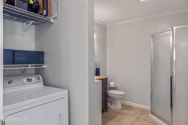 laundry area featuring washer / clothes dryer, laundry area, ornamental molding, and light tile patterned floors