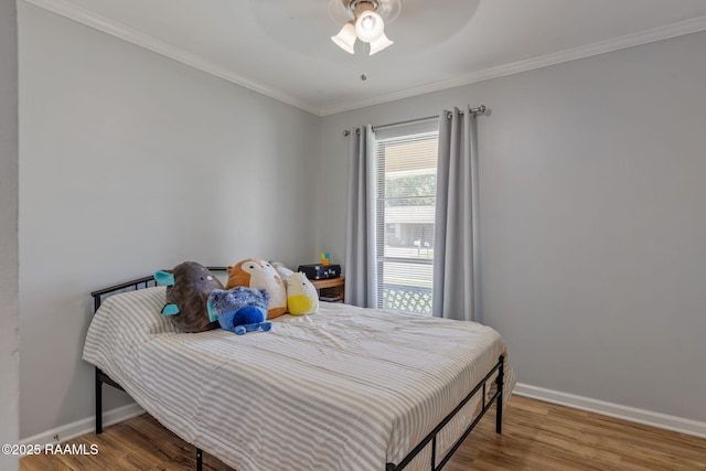 bedroom with baseboards, ceiling fan, ornamental molding, and wood finished floors