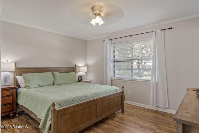 bedroom with crown molding, a ceiling fan, baseboards, and wood finished floors