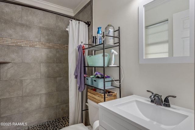 full bathroom with crown molding, a tile shower, toilet, and vanity