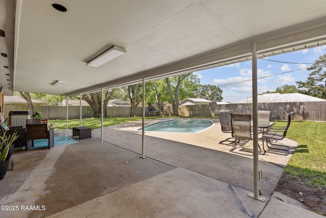 view of swimming pool featuring a fenced backyard, a fenced in pool, a patio, and a lawn