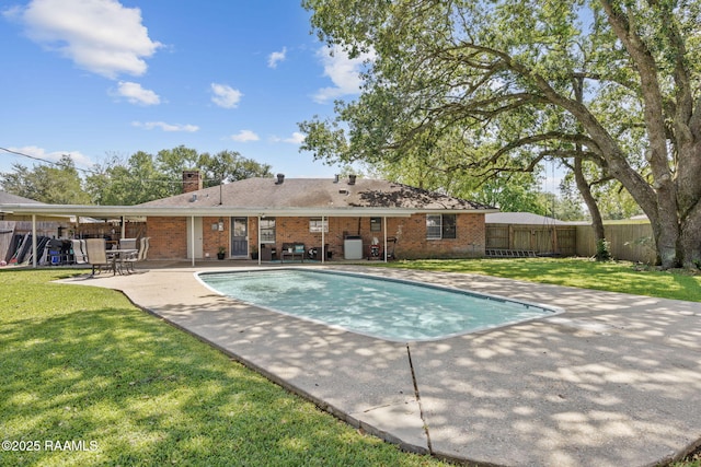 view of swimming pool featuring a lawn, a fenced in pool, a fenced backyard, and a patio area
