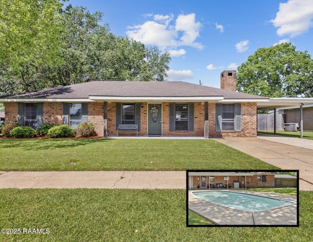 ranch-style home featuring fence, a front lawn, brick siding, an attached carport, and a chimney
