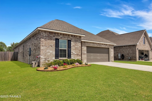 113 Spider Lily Ln, Lafayette, LA 70508 - view of front of property featuring concrete driveway, a front lawn, an attached garage, fence, and brick siding