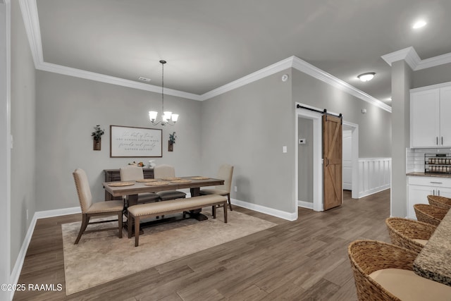 113 Spider Lily Ln, Lafayette, LA 70508 - dining area with a barn door, an inviting chandelier, ornamental molding, baseboards, and dark wood-style flooring